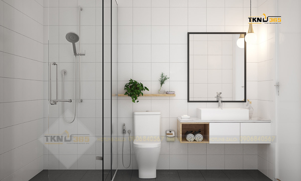 Phòng tắm màu trắng đơn giản, trang trí bằng vài chậu cây xanh và bóng đèn dây tóc