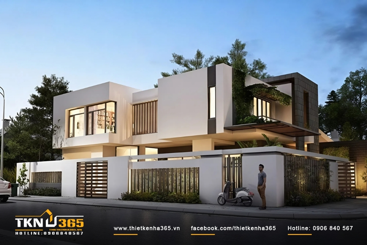 Ngôi nhà với thiết kế không gian mở nhiều cửa sổ, có gara ô tô và tiểu cảnh xanh