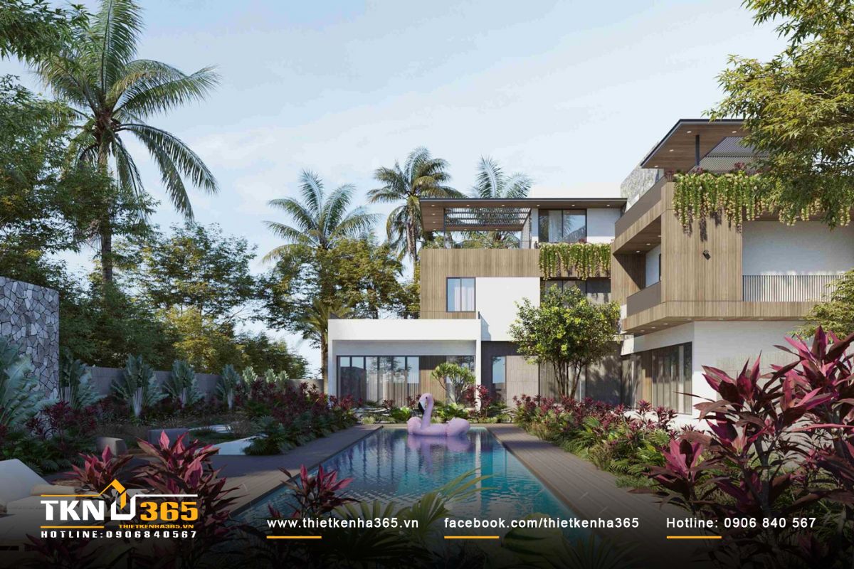 Hồ bơi hình chữ nhật hiện đại được bao trọn bởi cây cối xung quanh tạo không gian thư giãn