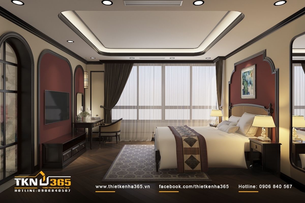 Giường ngủ đặt ở trung tâm phòng với đầu giường bằng mây tre đan, trong khi bàn làm việc gần cửa sổ để tận dụng ánh sáng tự nhiên