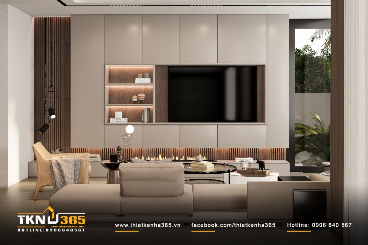 Ánh sáng tự nhiên tràn qua hệ cửa kính lớn, phản chiếu lên bề mặt vật liệu, giúp phòng khách luôn sáng và thoáng