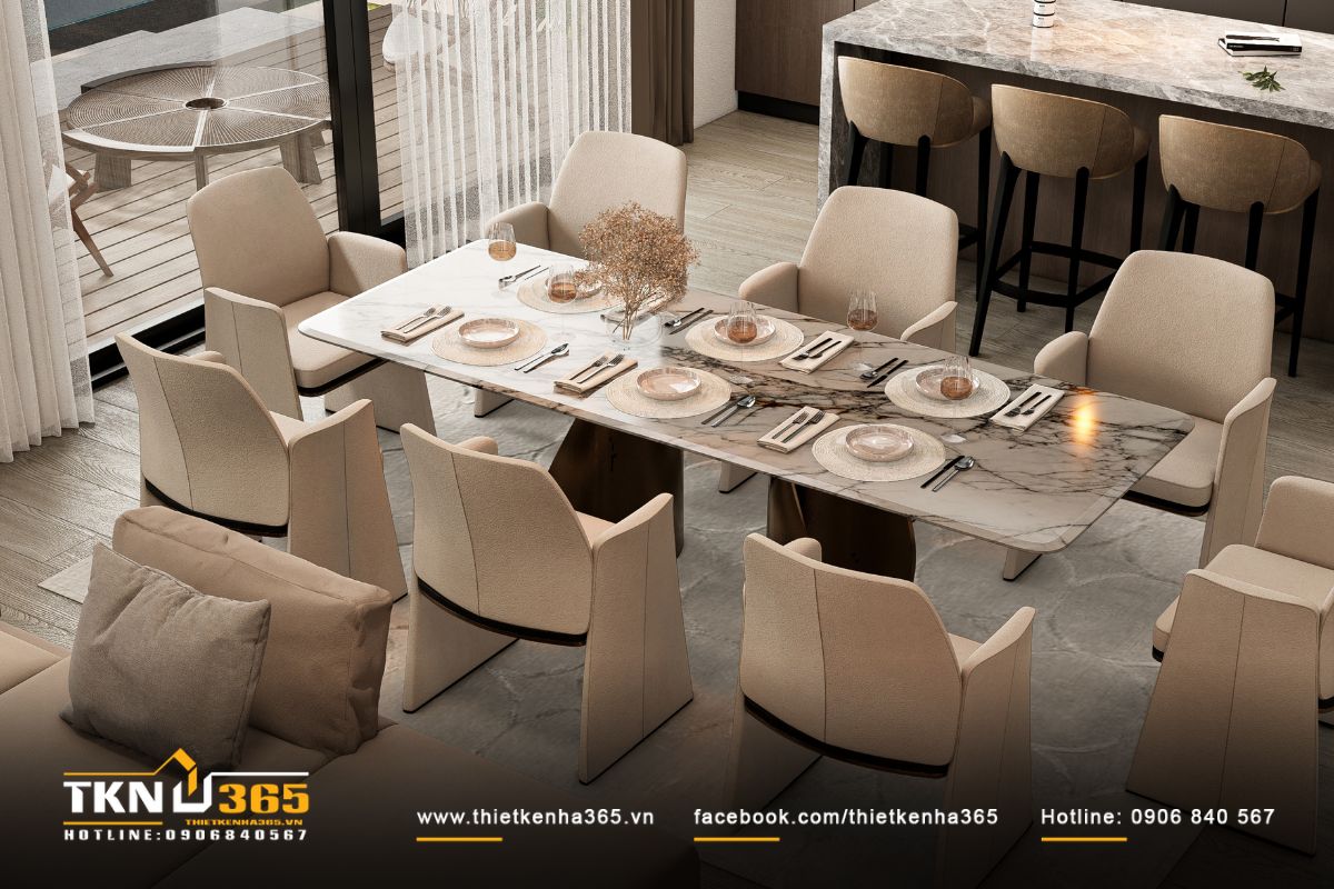 Bàn ăn đặt trên thảm màu trung tính, phân chia rõ ràng từng khu vực chức năng trong không gian sinh hoạt chung