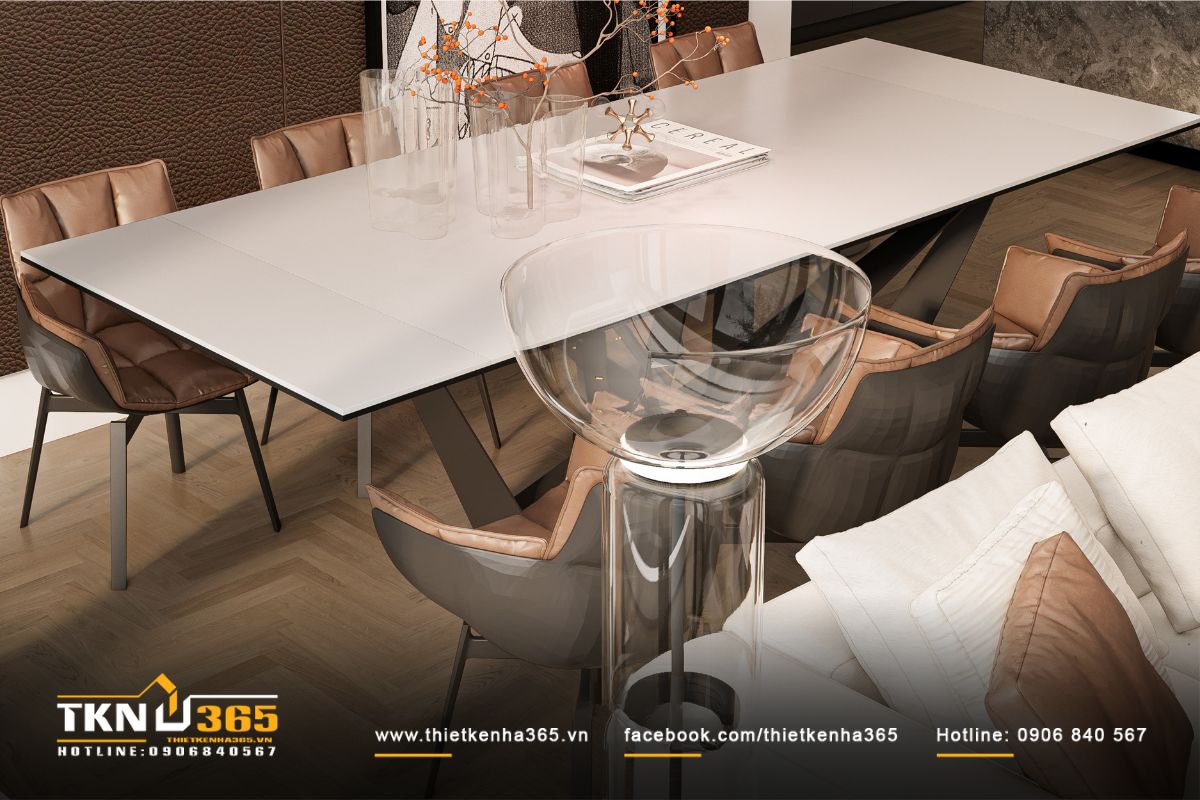 Bề mặt bàn ăn dài màu trắng trang nhã, ghế da màu nâu êm ái đối lập dịu nhẹ giữa cảm xúc và vật liệu