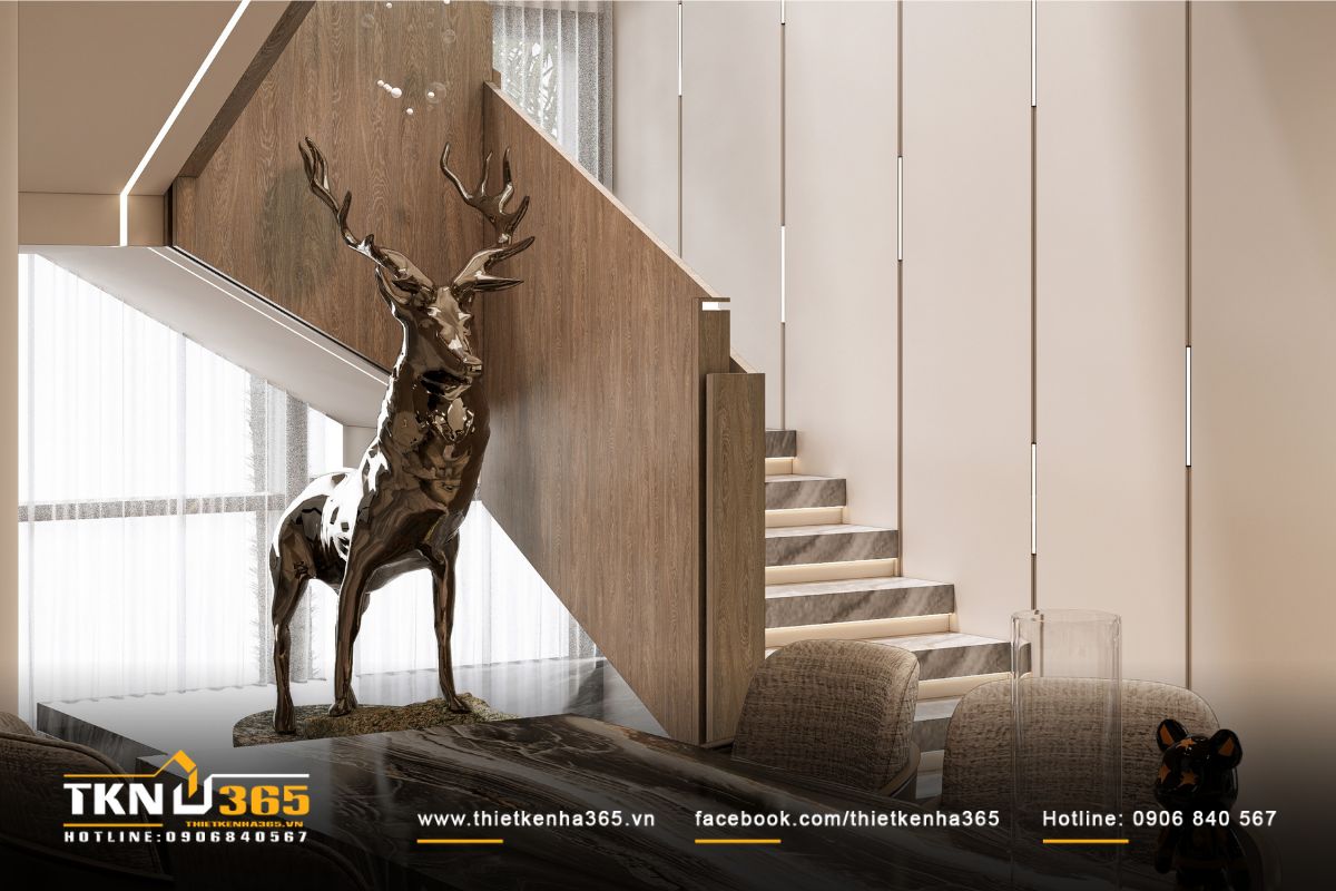 Cầu thang ốp đá marble kết hợp lan can gỗ và đèn LED hắt sáng tinh tế, gợi nhịp điệu ánh sáng mềm mại trong không gian