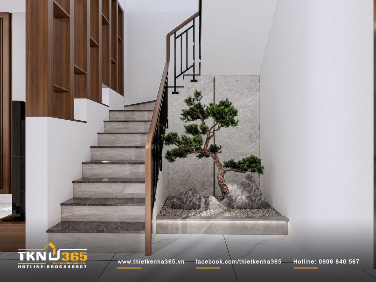 Kệ gỗ và mảng ốp đá kết hợp lan can kim loại tạo nên không gian cầu thang mạch lạc, mang tính thẩm mỹ cao