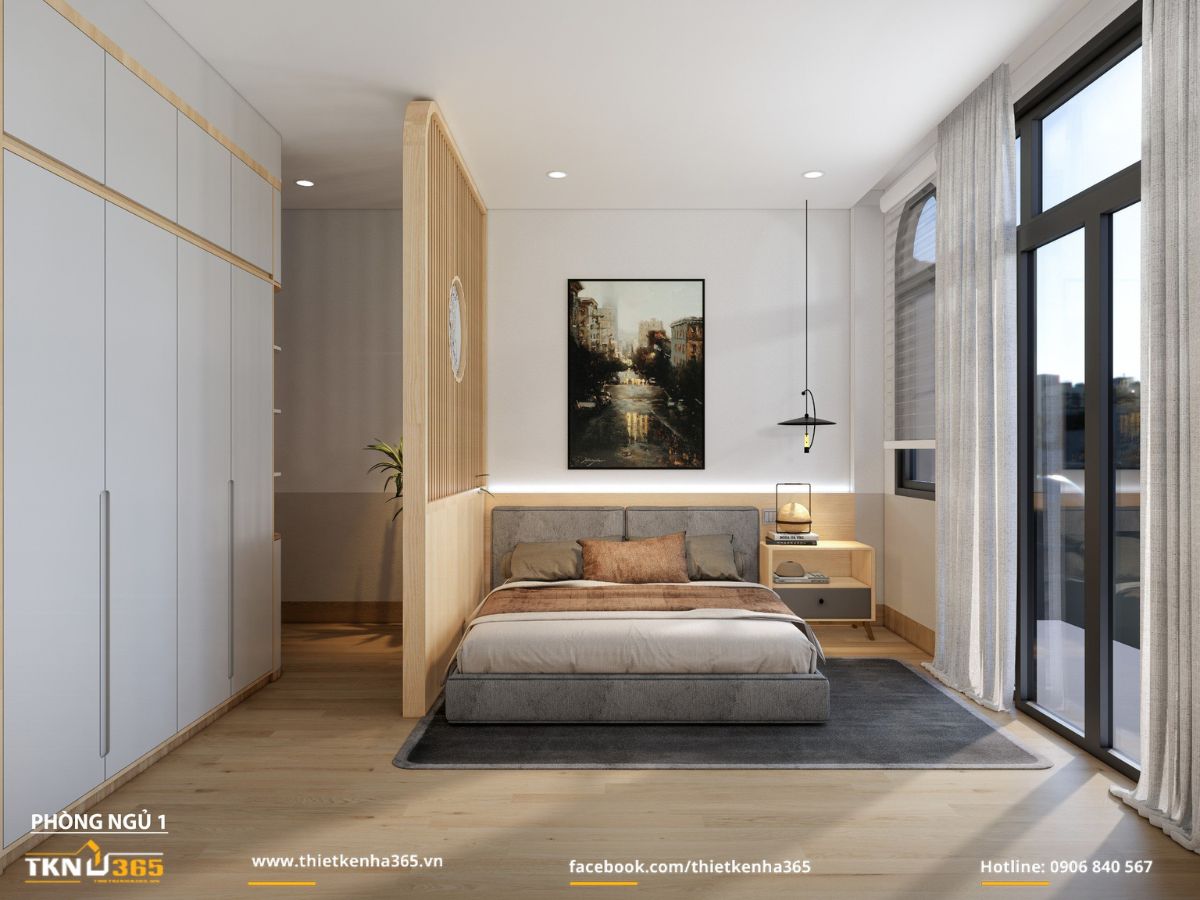 Giường bọc nệm xám hướng ra ban công, rèm voan ghi sáng giúp ánh sáng vào phòng nhẹ và êm hơn