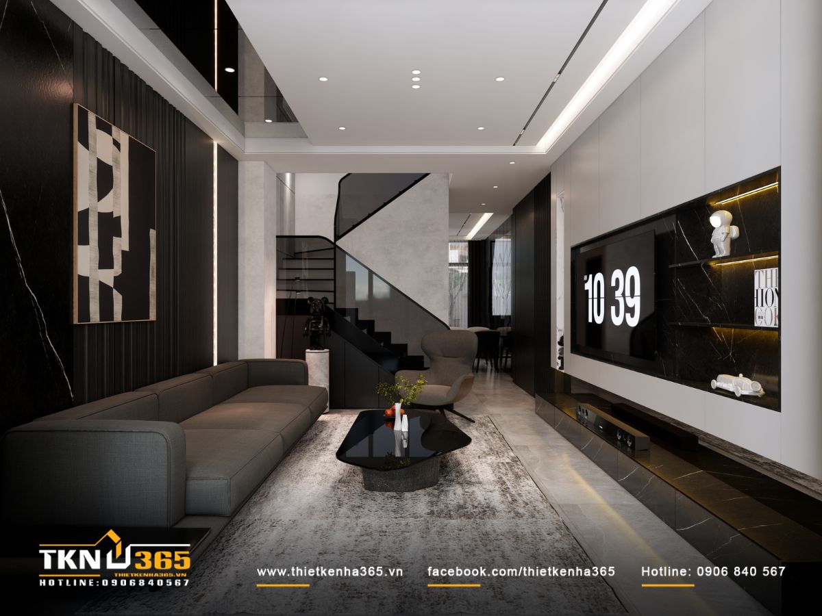 Sofa màu ghi đặt dọc theo tường phòng khách, giữ bố cục gọn gàng trong không gian nhà phố hẹp ngang