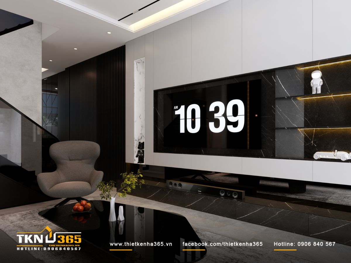 Khu vực kệ tivi kết hợp đá đen và ánh sáng ẩn tinh tế, tạo điểm nhấn sắc sảo cho phòng khách nhà phố