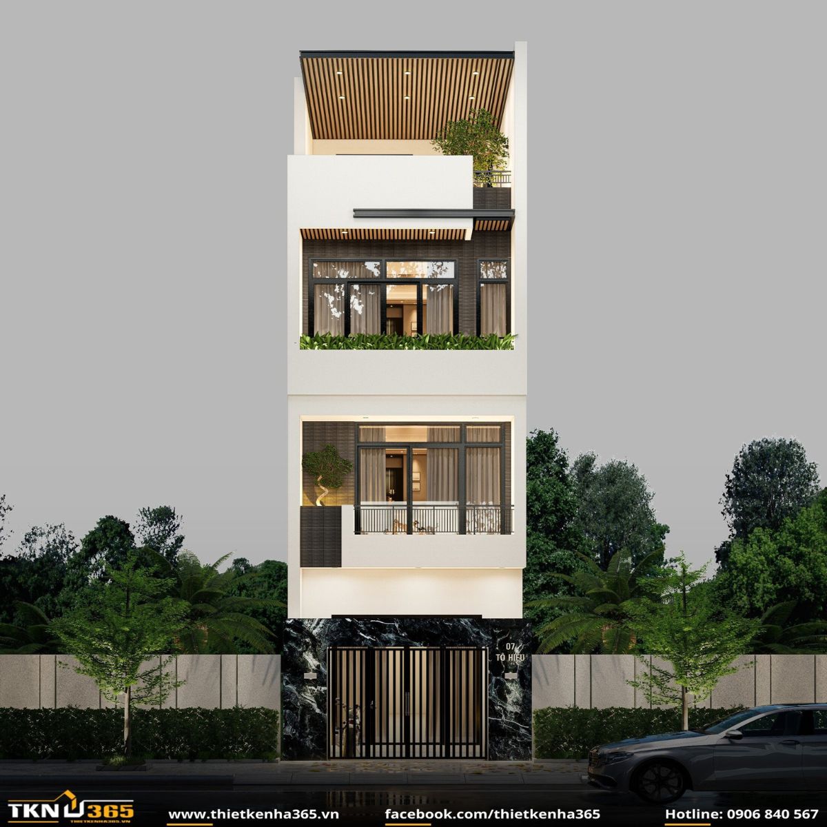 Mặt tiền Nhà Tô Hiệu nổi bật với mảng đá đen tầng trệt, hệ cửa kính lớn và ban công phủ xanh mang lại cảm giác hiện đại, trang nhã