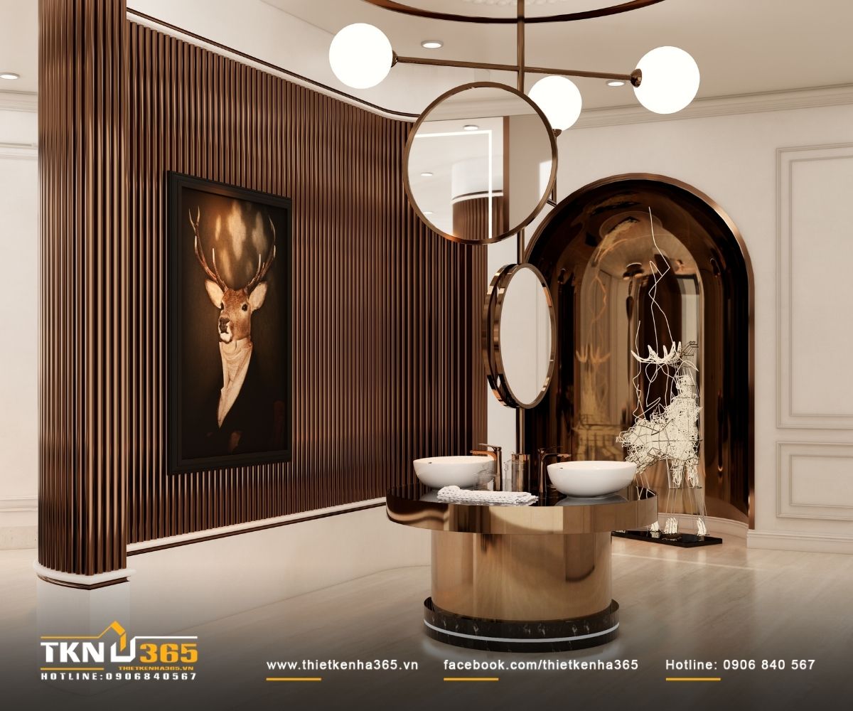 Khu vực lavabo đ&ocirc;i với mảng lam đứng bo cong v&agrave; gương tr&ograve;n, &aacute;nh s&aacute;ng gi&aacute;n tiếp gi&uacute;p bề mặt kim loại &aacute;nh đồng trở n&ecirc;n mềm mại