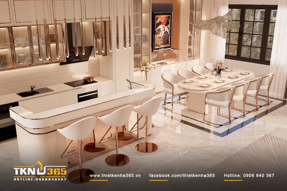 Khu bếp với đảo bếp bo cong, hệ tủ phẳng viền chỉ mảnh, thể hiện tinh thần tân cổ điển theo cách gọn gàng, hiện đại