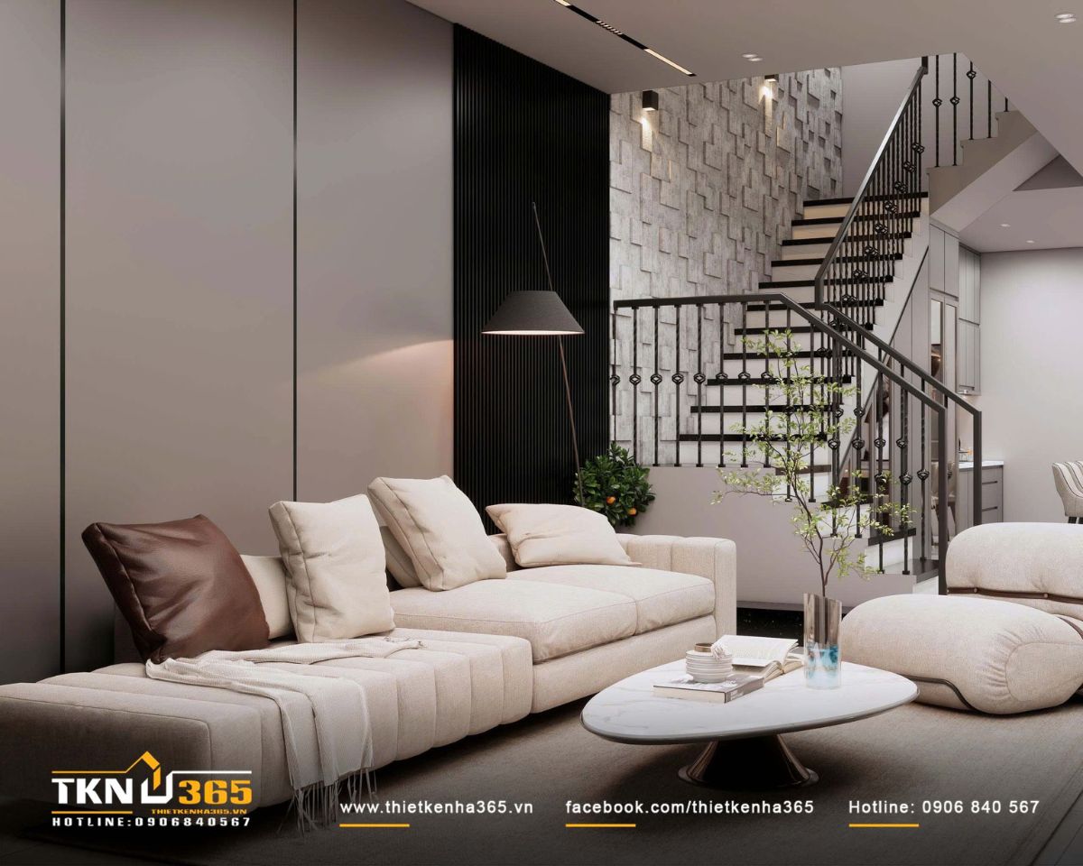 C&acirc;y xanh bố tr&iacute; rải r&aacute;c quanh ph&ograve;ng kh&aacute;ch đ&oacute;ng vai tr&ograve; l&agrave;m mềm bề mặt vật liệu đ&aacute;, gỗ v&agrave; kim loại, ho&agrave;n thiện tổng thể nội thất theo tinh thần tiết chế nhưng vẫn gần gũi