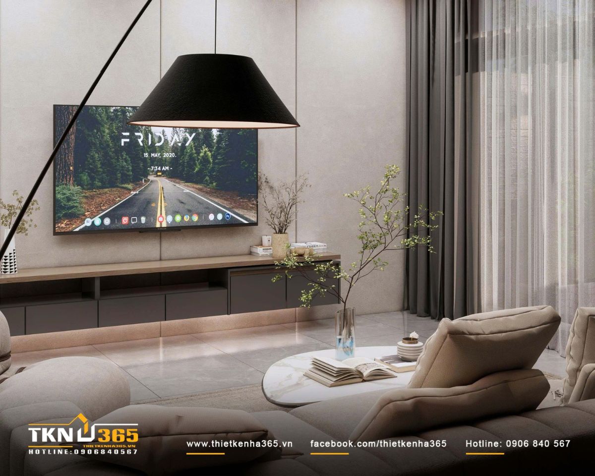 Đ&egrave;n s&agrave;n chụp đen đặt lệch b&ecirc;n ghế lounge tạo điểm nhấn h&igrave;nh khối, đồng thời bổ sung lớp &aacute;nh s&aacute;ng ấm cho kh&ocirc;ng gian sinh hoạt buổi tối