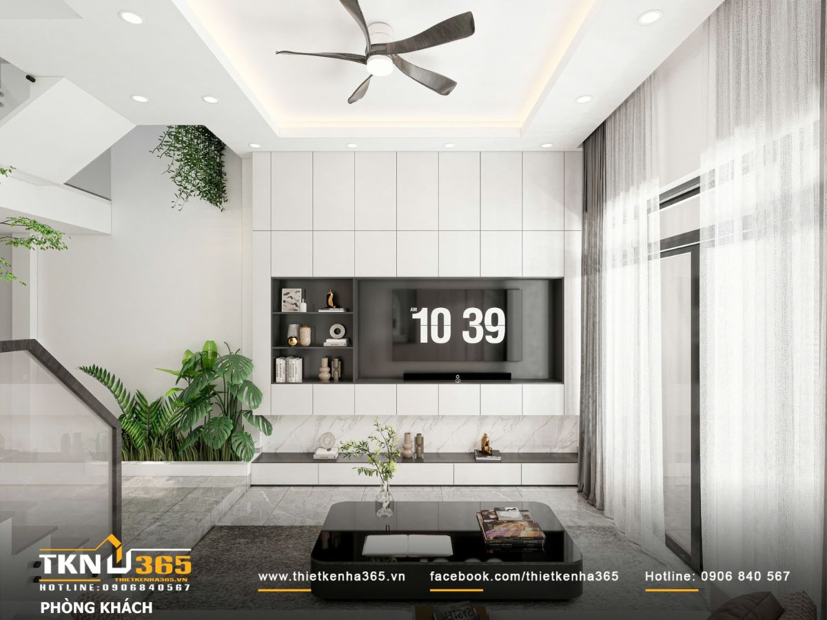 Hệ tủ tivi &acirc;m tường k&eacute;o d&agrave;i kết hợp &aacute;nh s&aacute;ng gi&aacute;n tiếp v&agrave; r&egrave;m hai lớp, gi&uacute;p khu vực sinh hoạt chung s&aacute;ng dịu v&agrave; rộng hơn diện t&iacute;ch thực