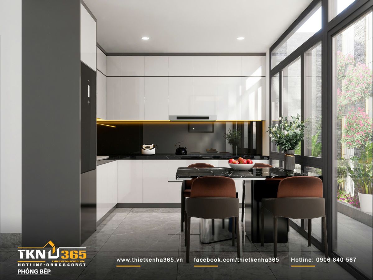 Khu vực bếp thiết kế liền mạch với kh&ocirc;ng gian sinh hoạt chung, sử dụng bảng m&agrave;u trắng - đen tiết chế, tạo cảm gi&aacute;c gọn g&agrave;ng v&agrave; hiện đại