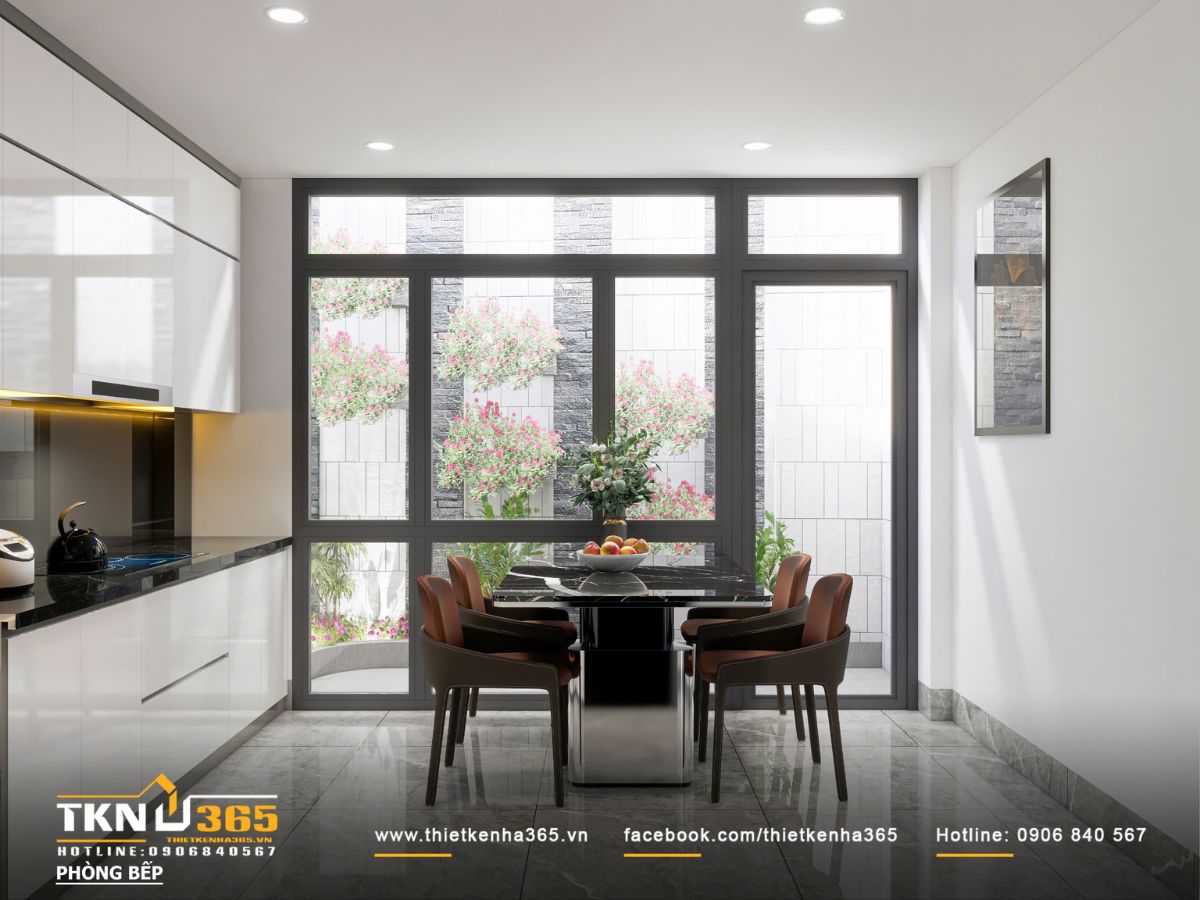B&agrave;n ăn đặt s&aacute;t hệ cửa k&iacute;nh lớn, tận dụng &aacute;nh s&aacute;ng tự nhi&ecirc;n v&agrave; khoảng xanh b&ecirc;n ngo&agrave;i để tăng sự tho&aacute;ng đ&atilde;ng cho kh&ocirc;ng gian bếp - ăn