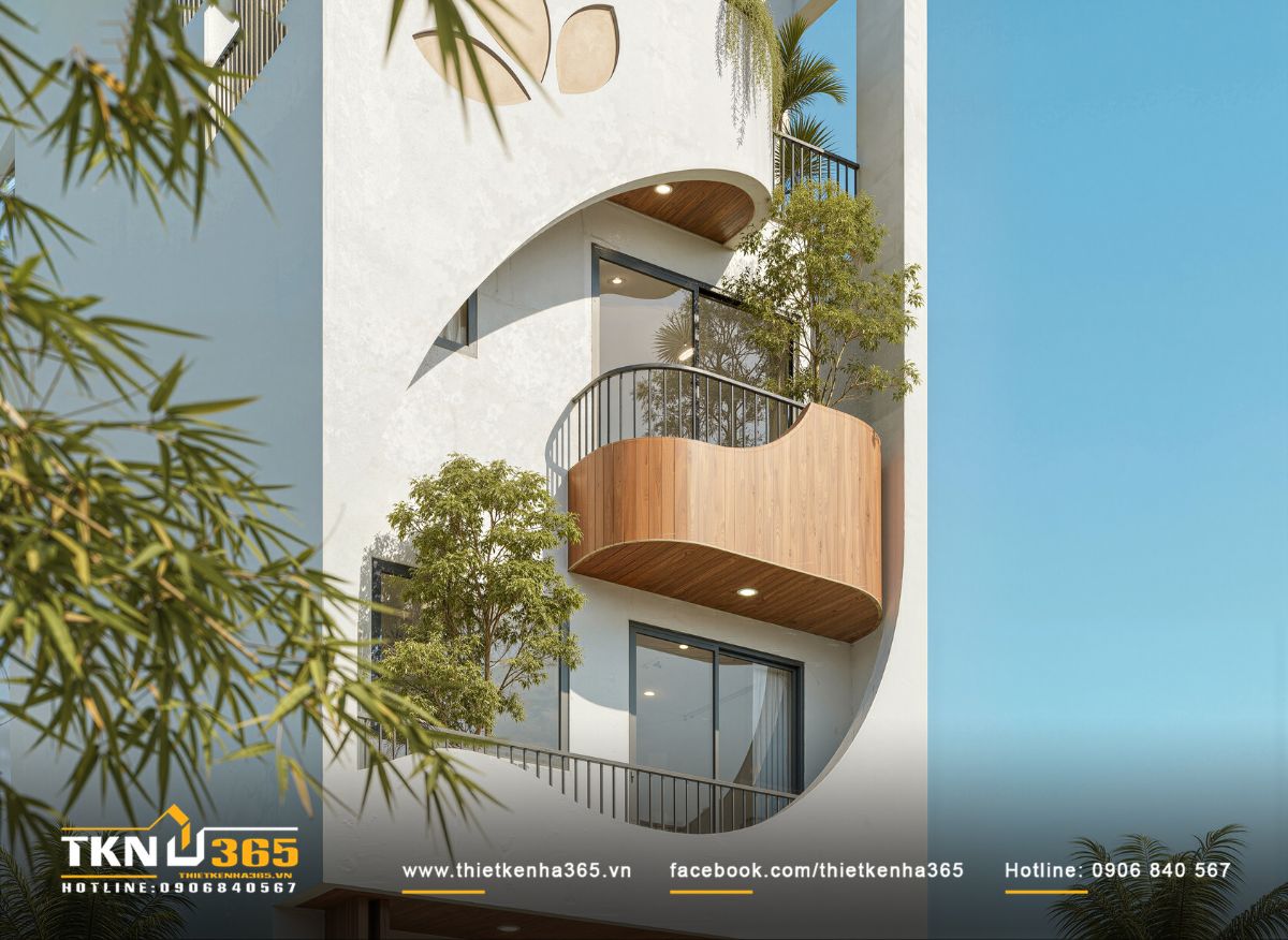 Ban c&ocirc;ng cong c&ugrave;ng mảng c&acirc;y xanh mang lại cảm gi&aacute;c mềm mại cho thiết kế mặt tiền nh&agrave; phố 4 tầng