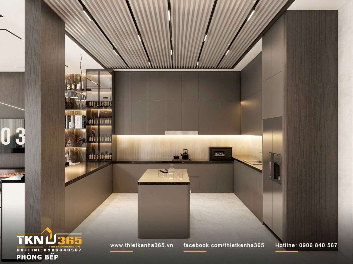 Hệ tủ bếp phẳng giấu tay nắm kết hợp đá tối màu và ánh sáng hắt giúp không gian gọn gàng, rõ từng lớp vật liệu