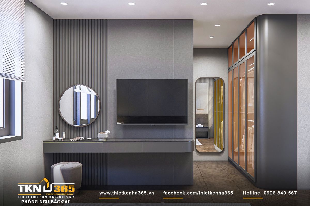 Hệ tủ kính khung kim loại tối mang lại độ phản chiếu nhẹ, giúp không gian thay đồ trở nên thoáng và có chiều sâu