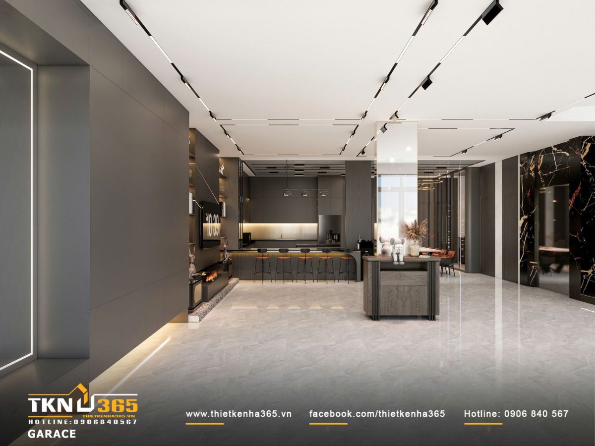 Không gian garage sử dụng bảng màu xám trầm kết hợp đá bóng và ánh sáng âm trần, tạo cảm giác rộng và liền mạch với khu bếp phía sau