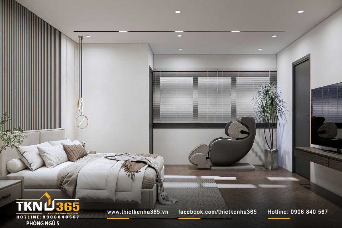 Góc thư giãn mở rộng với ghế lounge cạnh cửa sổ, nơi ánh sáng tự nhiên được kiểm soát qua hệ rèm, tạo cảm giác nghỉ ngơi trọn vẹn