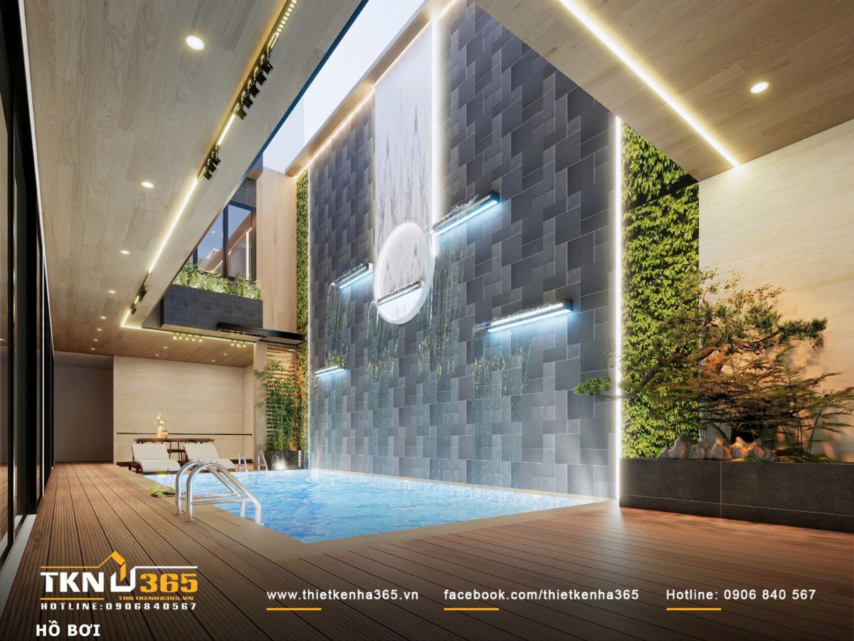 Tường nước với lớp đá tối màu và ánh sáng hắt tạo nên bề mặt chuyển động, góp phần giảm nhiệt và tăng độ ẩm cho không gian
