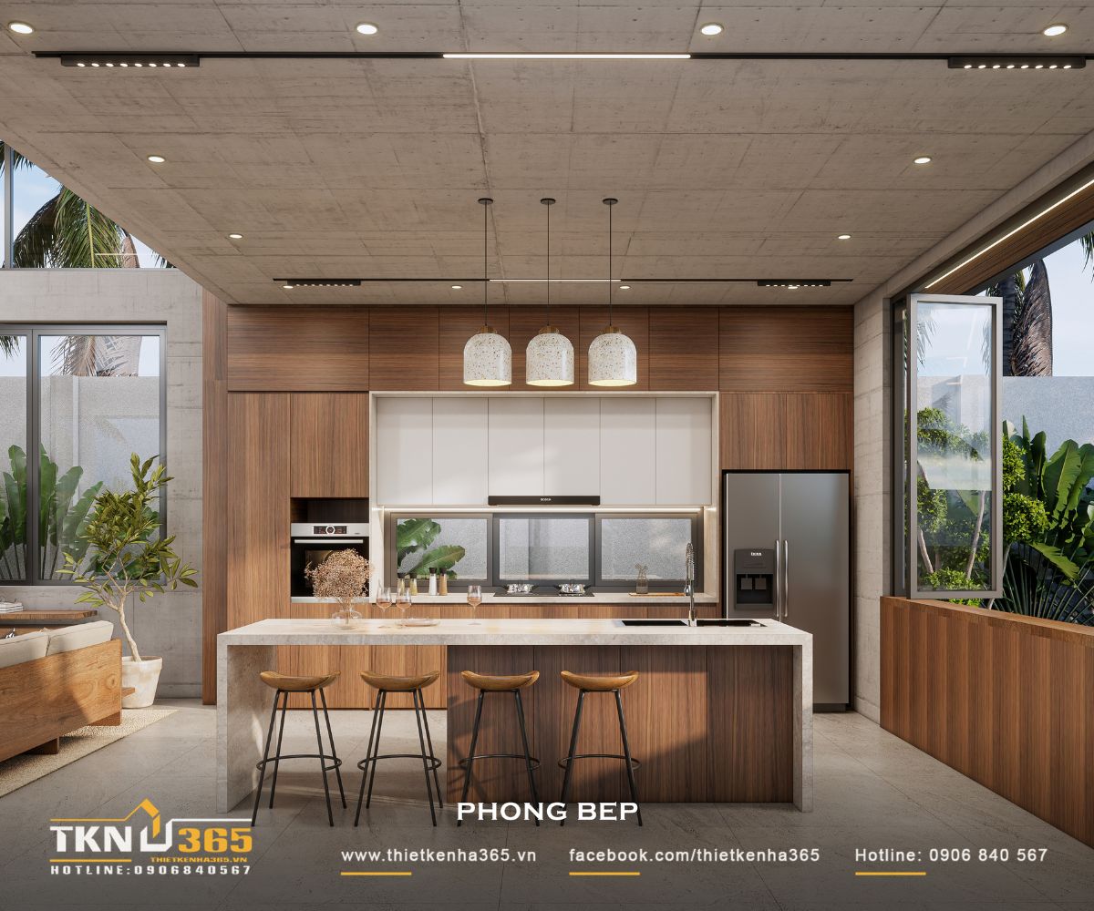 Bảng màu gỗ nâu, trắng và bề mặt đá sáng tiếp tục ngôn ngữ vật liệu của phòng khách, tạo sự liền mạch cho không gian chung