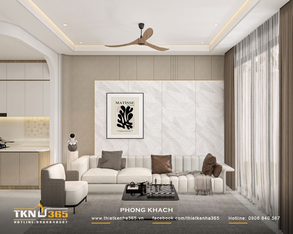 Phòng khách nhà phố 3 tầng bố trí gọn gàng với sofa dài sát tường, bàn trà thấp và cửa kính lớn giúp không gian thêm thoáng đãng