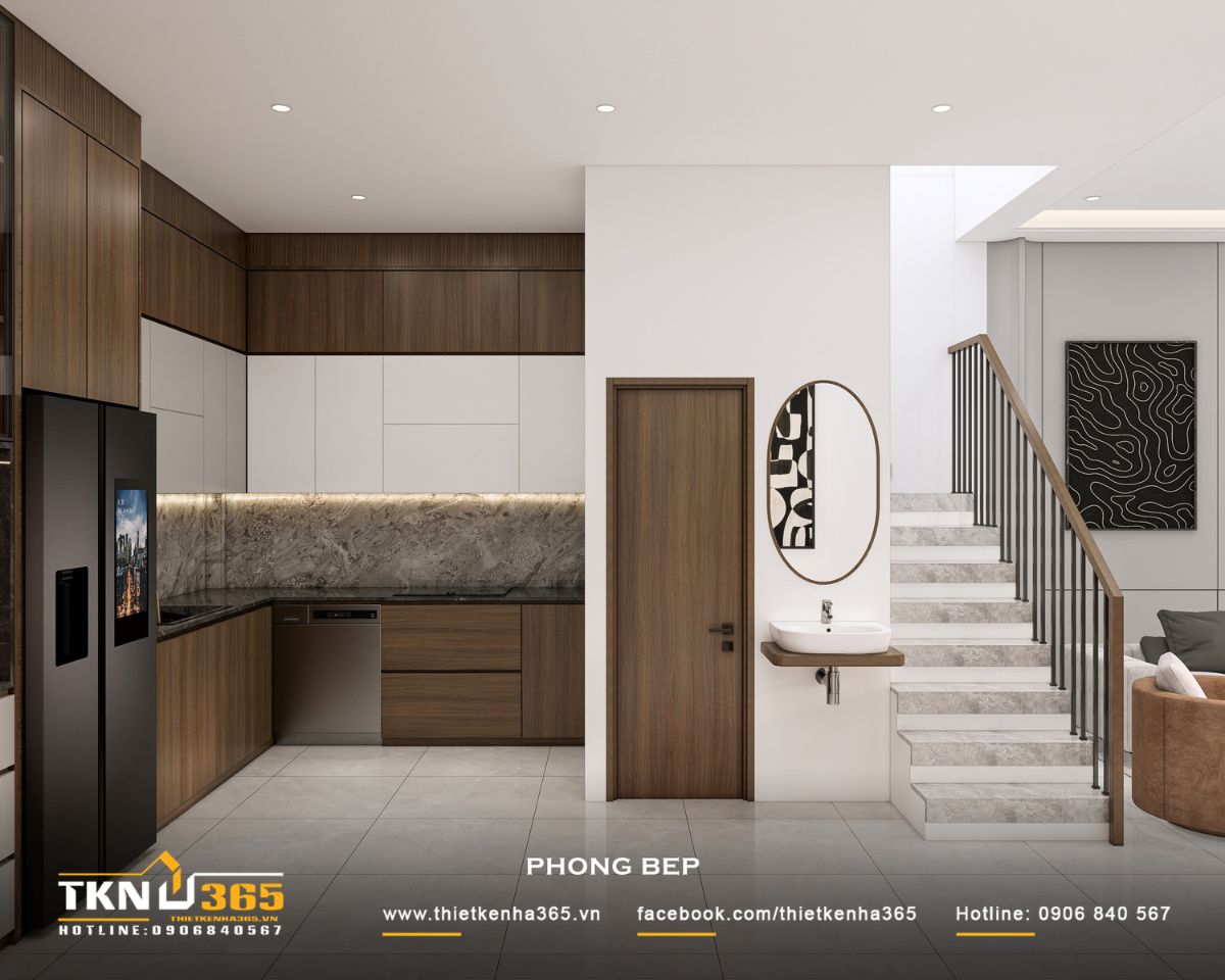 Nhà phố 3 tầng B’S House giữ sự riêng tư trong từng khoảng mở 17 Hệ tủ bếp chữ L của nhà phố 3 tầng kết hợp gỗ nâu, cánh tủ sáng màu và thiết bị âm tủ, tối ưu lưu trữ và giữ khu vực nấu nướng gọn gàng